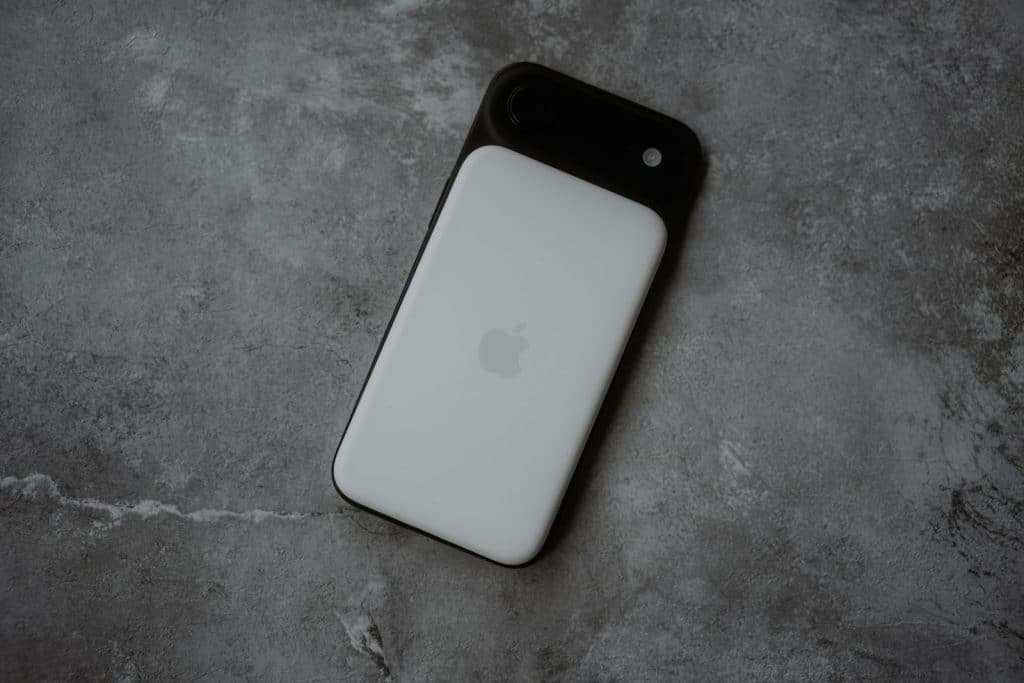 White smartphone with black camera lens attachment.
